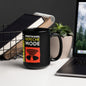 1987 Depeche Mode mug in black featuring Behind the Wheel design on office desk with laptop and plant
