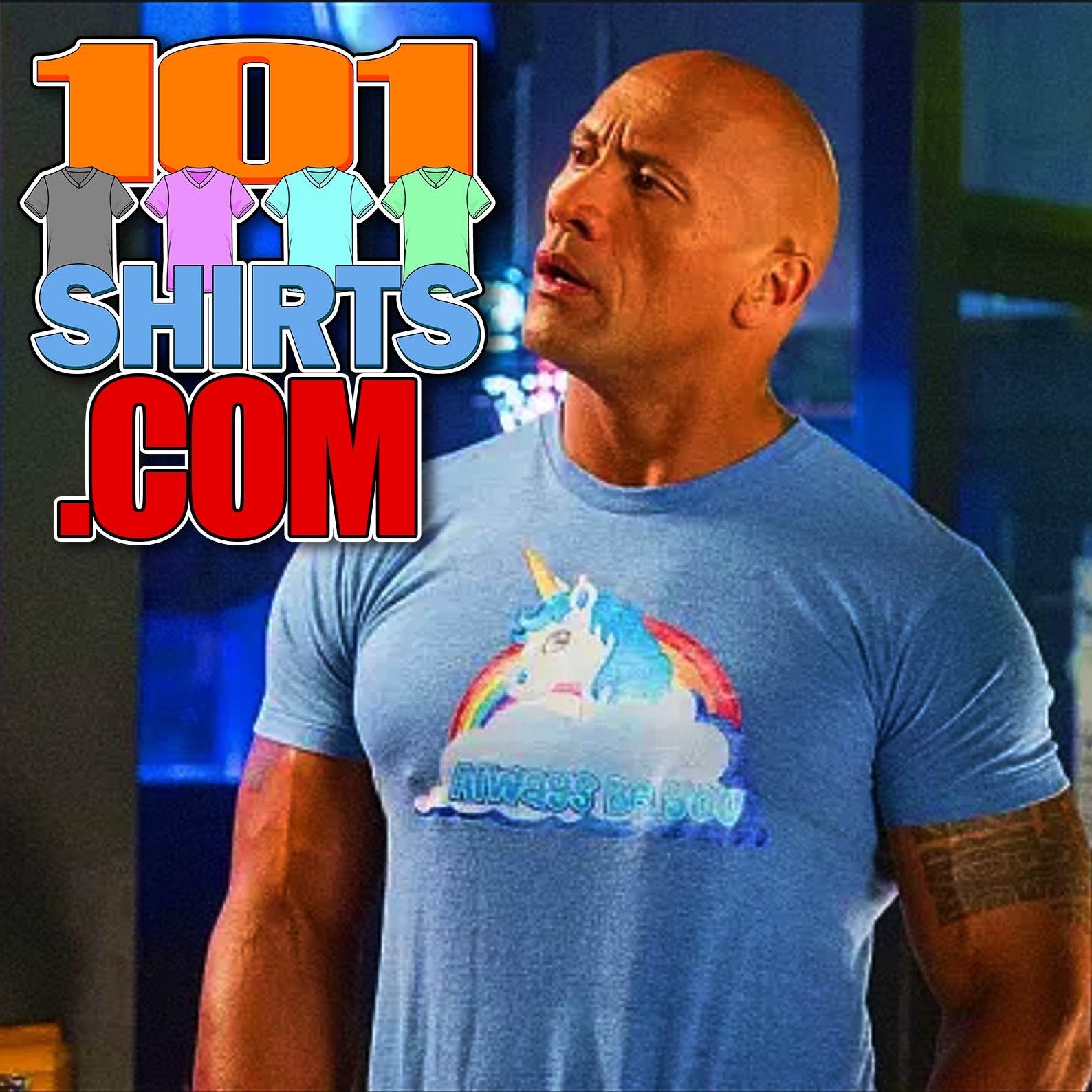 Central Intelligence unicorn shirt worn by muscular man in blue with colorful unicorn and rainbow design